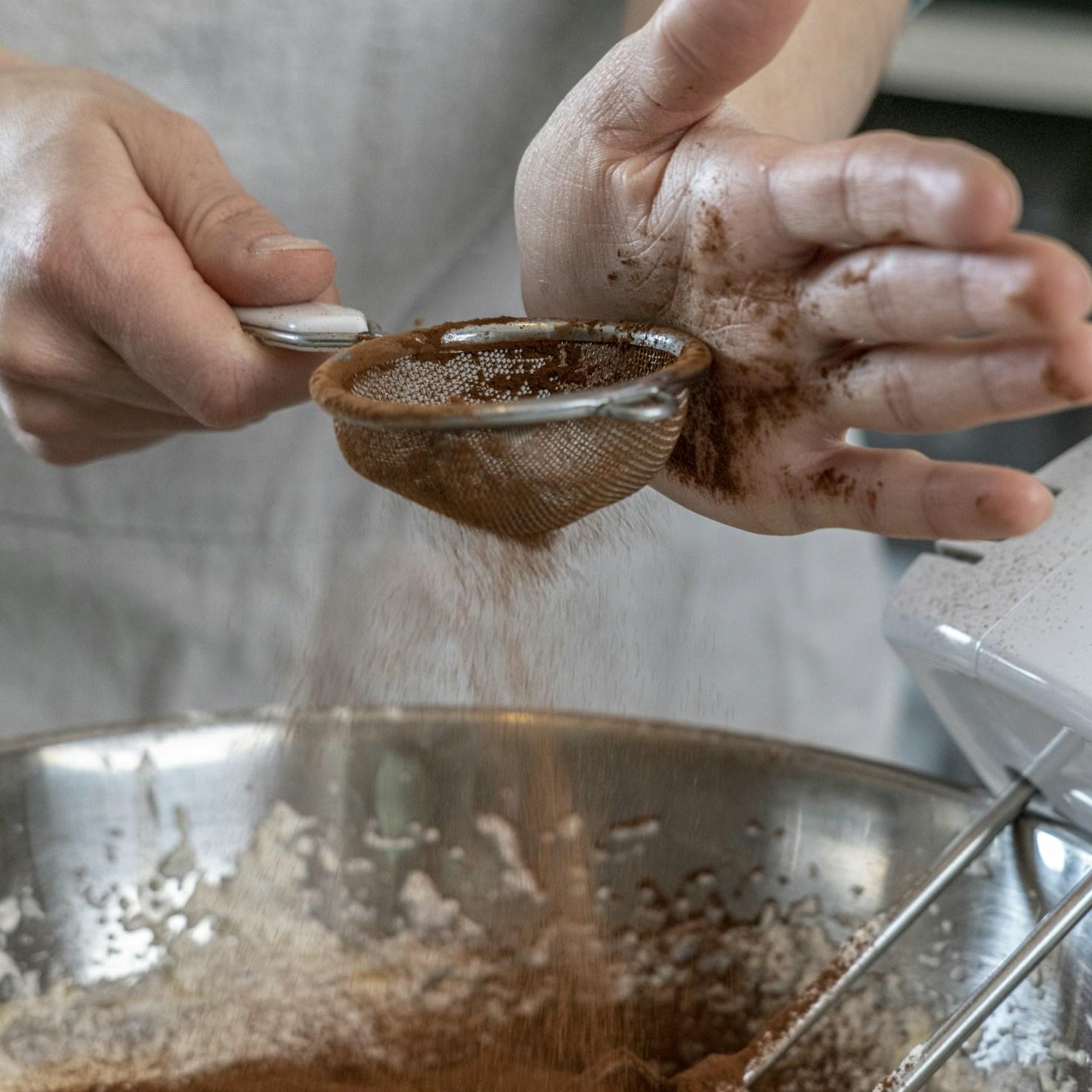 Community members collaborating in a contemporary kitchen, sharing recipes and techniques